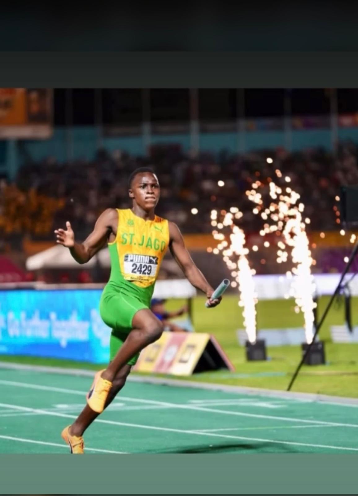 Procore Management student-athlete anchoring a relay under stadium lights