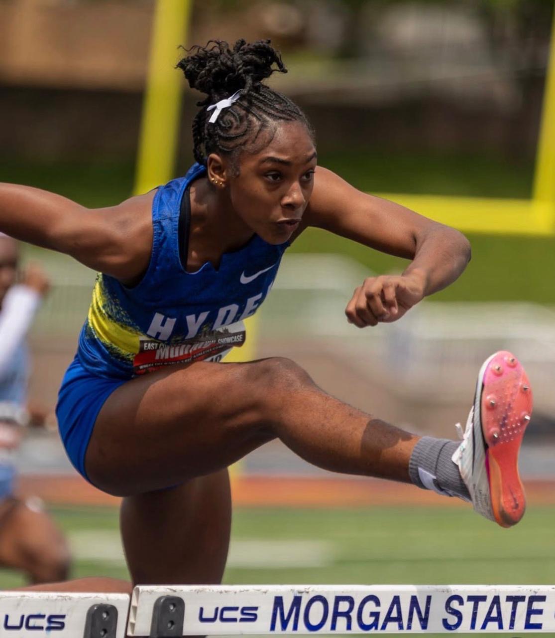 Procore Management student-athlete clearing a hurdle in competition